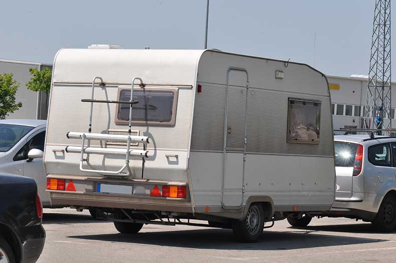 Caravan attached to a car on the road